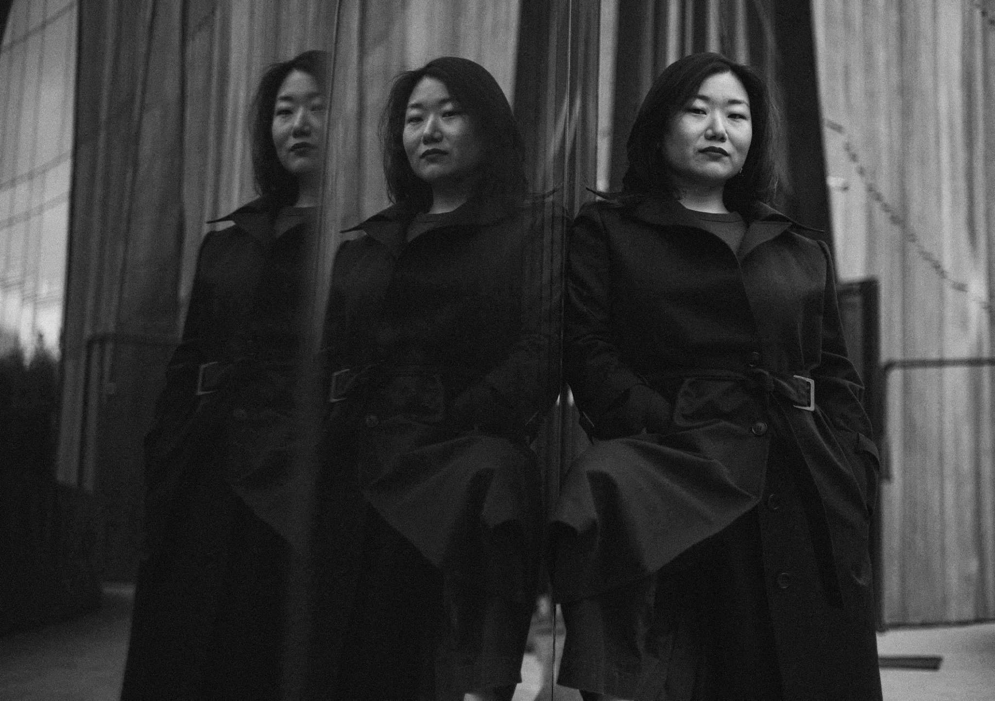 Ksenia Kim beside a reflective window